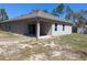 Inviting backyard with a covered patio, well-kept lawn, and plenty of space for relaxation and entertainment at 10240 Meadow Wren Ave, Weeki Wachee, FL 34613