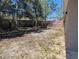 Large fenced backyard featuring mature trees, providing privacy and a serene outdoor environment at 10240 Meadow Wren Ave, Weeki Wachee, FL 34613