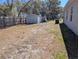 Spacious fenced backyard with a storage shed offering ample space for outdoor activities and relaxation at 10240 Meadow Wren Ave, Weeki Wachee, FL 34613