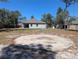 Spacious backyard featuring a circular area, storage shed, and room for various outdoor amenities at 10240 Meadow Wren Ave, Weeki Wachee, FL 34613