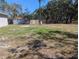 Expansive backyard with a storage shed and mature trees, offering potential for landscaping or recreation at 10240 Meadow Wren Ave, Weeki Wachee, FL 34613