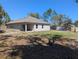 Expansive backyard with a well-maintained lawn, storage shed, and potential for outdoor activities at 10240 Meadow Wren Ave, Weeki Wachee, FL 34613