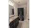 Bathroom features a dual sink vanity with granite counters and shower at 10240 Meadow Wren Ave, Weeki Wachee, FL 34613