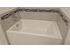 Clean, white bathtub with tile surround and chrome fixtures in the bathroom at 10240 Meadow Wren Ave, Weeki Wachee, FL 34613
