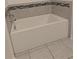Clean, white bathtub with tile surround and chrome fixtures in the bathroom at 10240 Meadow Wren Ave, Weeki Wachee, FL 34613