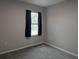 Bedroom with neutral walls, carpet flooring and a window at 10240 Meadow Wren Ave, Weeki Wachee, FL 34613