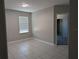 Bedroom featuring tile floors and a window, offering a bright, airy space at 10240 Meadow Wren Ave, Weeki Wachee, FL 34613