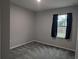 Cozy bedroom features plush carpeting, neutral walls and a window view at 10240 Meadow Wren Ave, Weeki Wachee, FL 34613