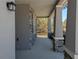 View of the stone-accented covered porch with views of the surrounding outdoors at 10240 Meadow Wren Ave, Weeki Wachee, FL 34613