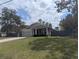 Charming single-story home with gray siding, stone accents, and a well-manicured lawn at 10240 Meadow Wren Ave, Weeki Wachee, FL 34613