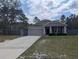 Charming single-Gathering home with a well-maintained lawn, gray exterior, and welcoming front porch at 10240 Meadow Wren Ave, Weeki Wachee, FL 34613