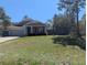 Well-maintained single-Gathering home featuring a lush lawn and mature trees at 10240 Meadow Wren Ave, Weeki Wachee, FL 34613
