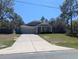 Charming single-story home with a well-manicured lawn and a two-car garage at 10240 Meadow Wren Ave, Weeki Wachee, FL 34613