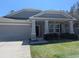 Inviting home with stone accents, covered porch, and an attached garage at 10240 Meadow Wren Ave, Weeki Wachee, FL 34613