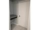 A white paneled door and granite countertop space in the hallway at 10240 Meadow Wren Ave, Weeki Wachee, FL 34613