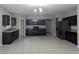 Modern kitchen features stainless steel appliances, granite counters, and ample cabinet space at 10240 Meadow Wren Ave, Weeki Wachee, FL 34613