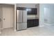 View of kitchen featuring stainless steel refrigerator, granite countertops, and dark cabinetry at 10240 Meadow Wren Ave, Weeki Wachee, FL 34613