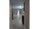 Spacious living area with tile flooring, ceiling fan, and backyard access at 10240 Meadow Wren Ave, Weeki Wachee, FL 34613