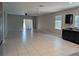 Expansive living area with backyard views, tile floors, and a ceiling fan at 10240 Meadow Wren Ave, Weeki Wachee, FL 34613