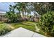 Lush backyard with mature trees, stone path and a well maintained privacy fence at 1031 Ridge View Ln, Palm Harbor, FL 34683