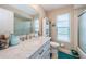 Modern bathroom featuring a white marble vanity, large mirror, and updated fixtures at 1031 Ridge View Ln, Palm Harbor, FL 34683