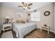Bedroom featuring a ceiling fan, wood flooring, and a comfortable bed with plush pillows at 1031 Ridge View Ln, Palm Harbor, FL 34683