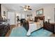 Comfortable bedroom with a ceiling fan, painting, work desk, and wood flooring at 1031 Ridge View Ln, Palm Harbor, FL 34683