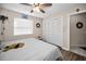 Bright bedroom showcasing a fan, hardwood floors and ample storage at 1031 Ridge View Ln, Palm Harbor, FL 34683