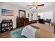 Cozy bedroom featuring a ceiling fan, a study desk, and wood flooring at 1031 Ridge View Ln, Palm Harbor, FL 34683