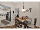 Charming dining area adjacent to the kitchen, featuring a glass-top table, wrought iron chairs, and decorative wall art at 1031 Ridge View Ln, Palm Harbor, FL 34683