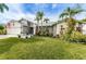 Beautiful single-story home with lush lawn, landscaping, and charming exterior at 1031 Ridge View Ln, Palm Harbor, FL 34683