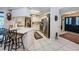 Well-lit kitchen features white cabinets, stainless steel appliances, and breakfast bar seating at 1031 Ridge View Ln, Palm Harbor, FL 34683