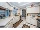 Bright kitchen features white cabinetry, sleek countertops, and stainless steel appliances and access to dining at 1031 Ridge View Ln, Palm Harbor, FL 34683