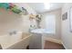 Functional laundry room with a washing machine, dryer, sink, and overhead shelving at 1031 Ridge View Ln, Palm Harbor, FL 34683