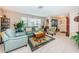 Inviting living room with tile floors, comfortable seating, and large windows at 1031 Ridge View Ln, Palm Harbor, FL 34683