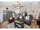 Bright and airy living room with hardwood floors, ceiling fan, and comfortable seating, adjacent to the dining area and kitchen at 1031 Ridge View Ln, Palm Harbor, FL 34683