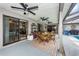 Cozy covered patio with ceiling fans, dining area, and view of the refreshing swimming pool at 1031 Ridge View Ln, Palm Harbor, FL 34683