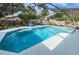 Relaxing screened-in pool area features sparkling blue water and comfortable seating for enjoying the outdoors at 1031 Ridge View Ln, Palm Harbor, FL 34683