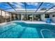 Stunning screened-in pool with spacious patio and comfortable seating, ideal for outdoor relaxation and entertaining at 1031 Ridge View Ln, Palm Harbor, FL 34683