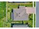 Aerial view of home with brick driveway, roof with skylights, fenced yard and manicured lawn at 11086 Sundrift Dr, Tampa, FL 33647