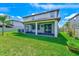Expansive backyard with a covered patio area provides space for outdoor relaxation and entertainment at 11086 Sundrift Dr, Tampa, FL 33647