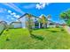 The well-manicured lawn and partial view of the back of the home create a serene outdoor space at 11086 Sundrift Dr, Tampa, FL 33647