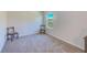 Cozy bedroom with carpet, two chairs, and a scenic window view at 11086 Sundrift Dr, Tampa, FL 33647