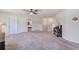 Carpeted bonus room featuring a ceiling fan, 2 doors, and railing at 11086 Sundrift Dr, Tampa, FL 33647