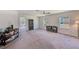 Large bonus room with multiple windows, ceiling fan, and doorway views at 11086 Sundrift Dr, Tampa, FL 33647