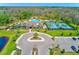 Aerial view of community clubhouse, pool, tennis courts, green space and parking lot at 11086 Sundrift Dr, Tampa, FL 33647