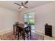 Dining room with dark wood table, four chairs, and view of the landscaped backyard at 11086 Sundrift Dr, Tampa, FL 33647