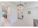 Dining area featuring a modern chandelier and view into kitchen and living area at 11086 Sundrift Dr, Tampa, FL 33647
