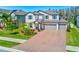 Beautiful two-story home with brick driveway, three-car garage, manicured lawn and charming curb appeal at 11086 Sundrift Dr, Tampa, FL 33647