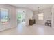 Welcoming foyer with decorative door, tile flooring, and view of the den with fan at 11086 Sundrift Dr, Tampa, FL 33647